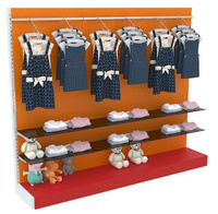 Модульная пристенная система с тонированными полками и пристенными поручнями для продажи детской одежды трёхсекционная K